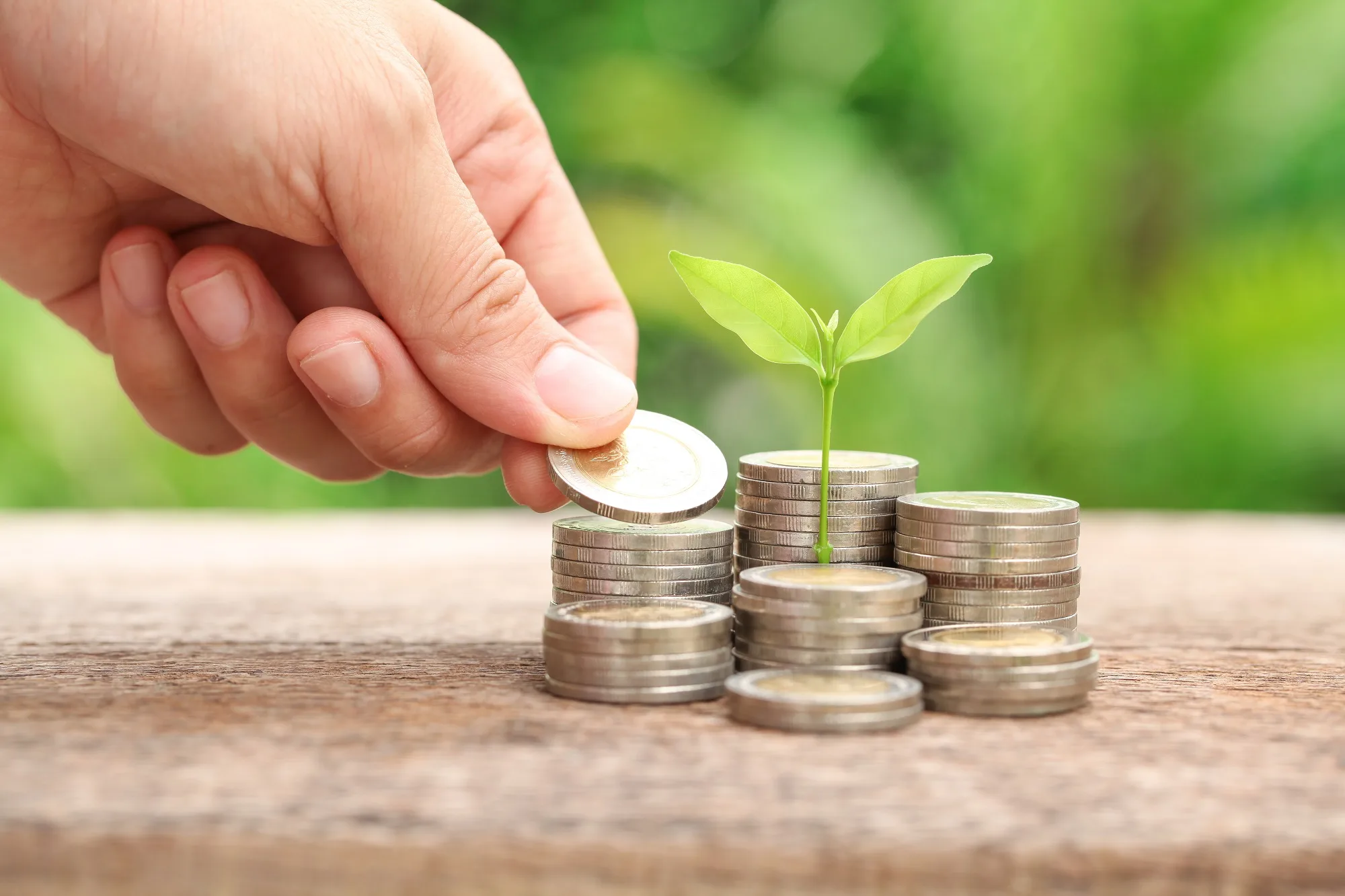 Business with csr practice / hand giving coins to stacks of coin